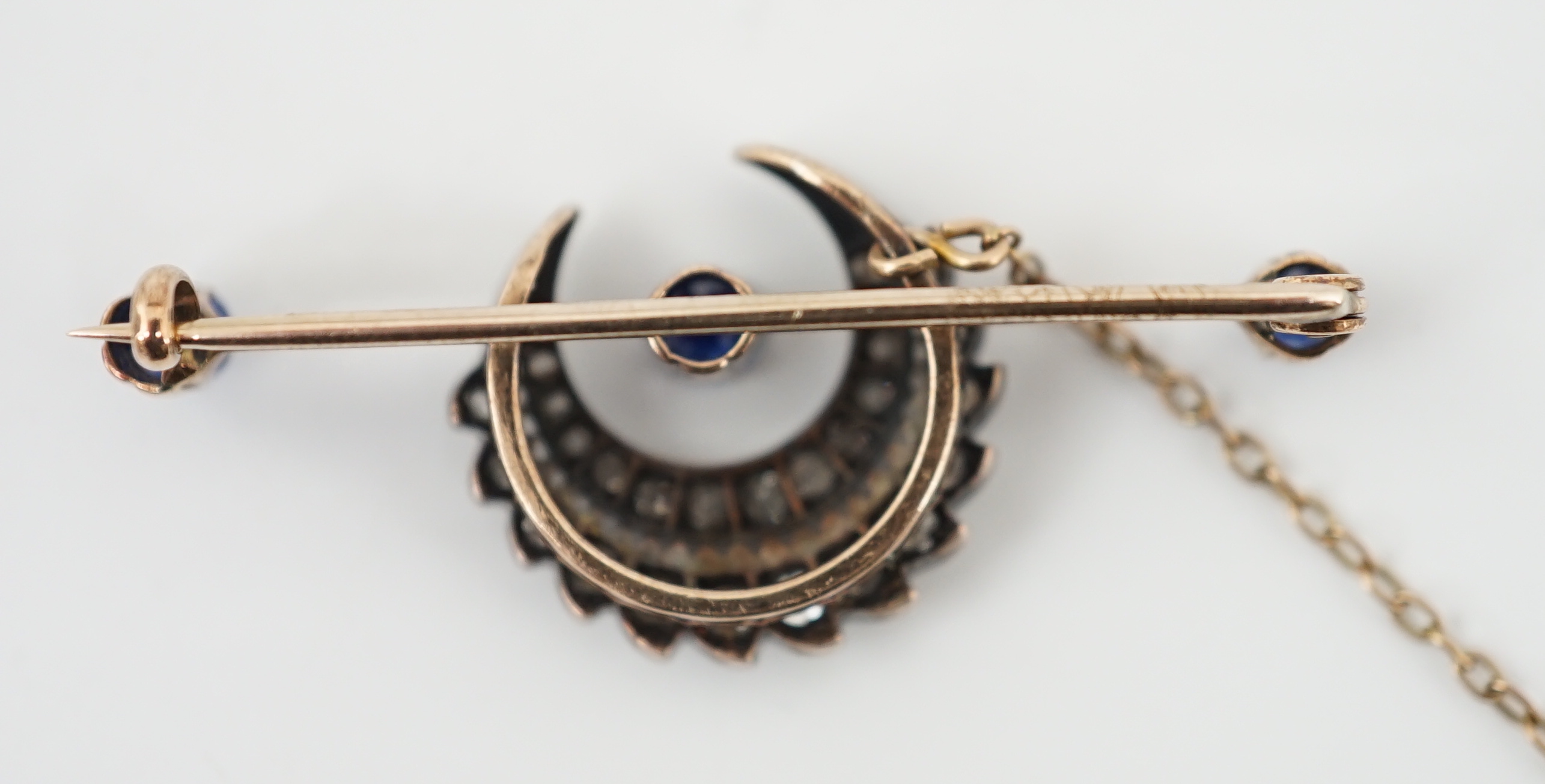 A Victorian gold and silver, three stone sapphire and diamond cluster set double crescent bar brooch